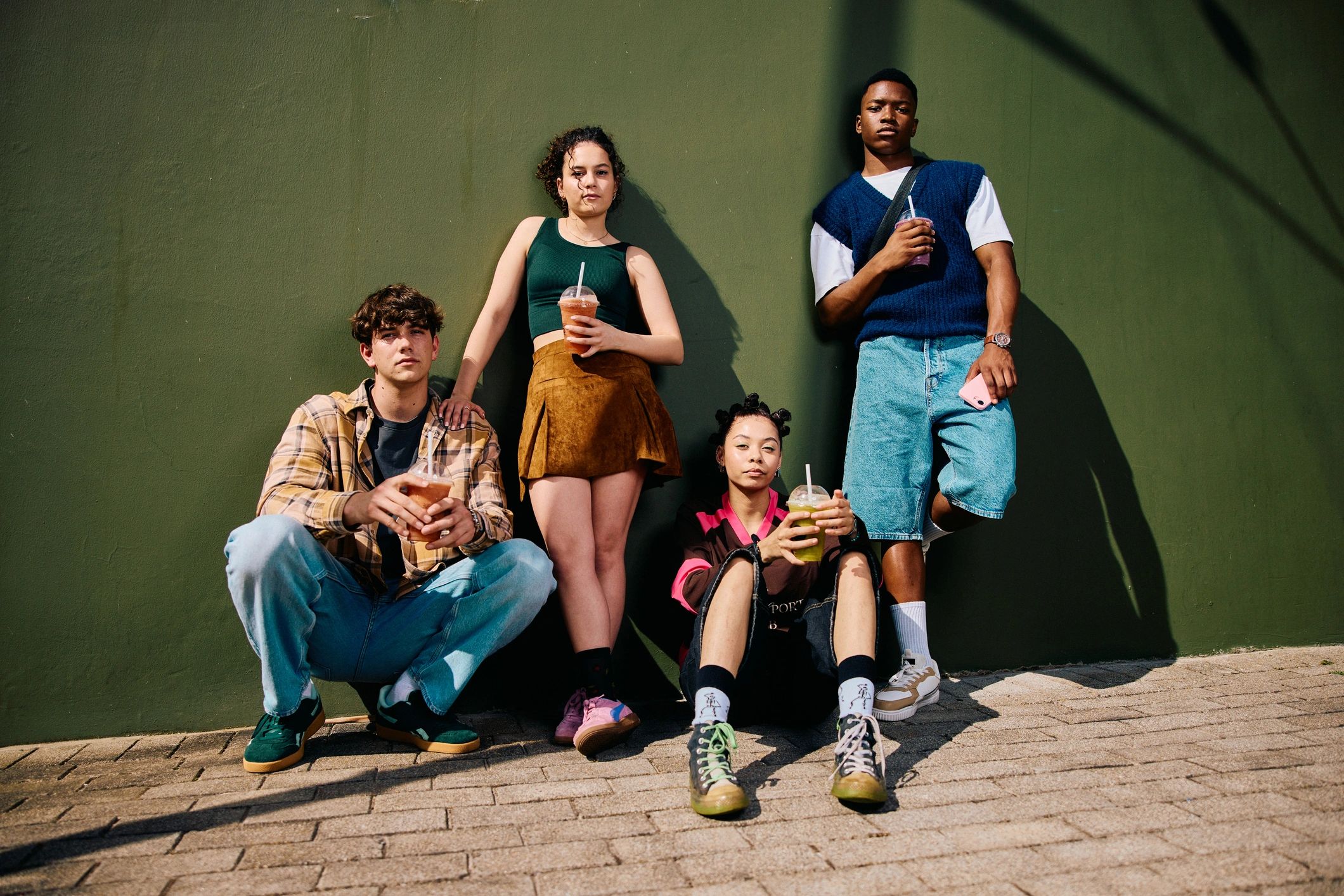 Teen friends gathered outdoors in a relaxed community setting
